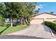 Charming single-story home with mature trees, a driveway and a two-car garage at 1823 Atrium Dr, Sun City Center, FL 33573