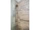 Walk-in shower featuring tiled walls, a glass door, and a shower head with multiple settings at 1823 Atrium Dr, Sun City Center, FL 33573