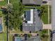 Overhead view of home, showcasing the backyard, lanai, and surrounding greenery at 1849 Del Robles Dr, Clearwater, FL 33764