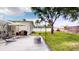 Spacious backyard featuring lush green grass, landscaping, and a comfortable seating area at 1849 Del Robles Dr, Clearwater, FL 33764