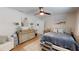 Spacious bedroom with ceiling fan, dresser, adjacent sitting area, and coordinated decor at 1849 Del Robles Dr, Clearwater, FL 33764