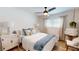 Light-filled bedroom with wood floors, neutral walls, ceiling fan and curated decor at 1849 Del Robles Dr, Clearwater, FL 33764