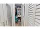 Well-organized walk-in closet with custom shelving, rods, and ample storage space at 1849 Del Robles Dr, Clearwater, FL 33764