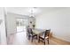 Bright dining room with hardwood floors and sliding glass doors to a backyard at 1849 Del Robles Dr, Clearwater, FL 33764