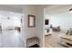 Bright hallway featuring wood-look floors, neutral walls, and an open view to the dining and living room at 1849 Del Robles Dr, Clearwater, FL 33764