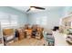 Home office filled with packed boxes with a desk, chair and multiple windows at 1849 Del Robles Dr, Clearwater, FL 33764