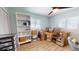 Home office with wood floors, built-in bookshelves, multiple windows and packed boxes at 1849 Del Robles Dr, Clearwater, FL 33764