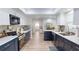 Modern kitchen with stainless steel appliances, white cabinets and lots of lighting at 1849 Del Robles Dr, Clearwater, FL 33764