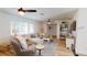Bright living room with hardwood floors, ceiling fan, sectional sofa and sunny window at 1849 Del Robles Dr, Clearwater, FL 33764