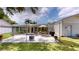 Spacious backyard patio featuring a seating area, grill, and lush landscaping at 1849 Del Robles Dr, Clearwater, FL 33764