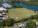 Aerial shot of a vibrant sports field next to the water, complete with players and equipment at 1849 Del Robles Dr, Clearwater, FL 33764