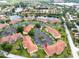Aerial view showcasing a vibrant community with lush greenery, tranquil ponds, and well-maintained landscaping at 21012 Picasso Ct # 201, Land O Lakes, FL 34637