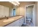 Double vanity bathroom with neutral countertops, a large mirror, and a separate toilet room at 21012 Picasso Ct # 201, Land O Lakes, FL 34637