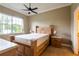 A comfortable bedroom with a wooden bed frame, large window, and natural light at 21012 Picasso Ct # 201, Land O Lakes, FL 34637
