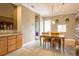 Bright dining room with a wooden table set, pendant lighting, and a passthrough view of the kitchen at 21012 Picasso Ct # 201, Land O Lakes, FL 34637
