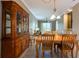 Traditional dining room featuring tile floors, a wooden table set and hutch, and a stylish light fixture at 21012 Picasso Ct # 201, Land O Lakes, FL 34637