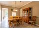 Bright dining room with a wooden table set, pendant lighting, and decorative hutch at 21012 Picasso Ct # 201, Land O Lakes, FL 34637
