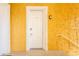 Condominium unit front door with decorative molding and yellow textured walls at 21012 Picasso Ct # 201, Land O Lakes, FL 34637