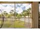 Relaxing lanai view featuring lush landscaping, manicured lawn, and swaying palm trees beyond the screened enclosure at 21012 Picasso Ct # 201, Land O Lakes, FL 34637