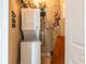 Compact laundry area with a stacked washer/dryer unit and storage shelves for convenience at 21012 Picasso Ct # 201, Land O Lakes, FL 34637