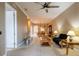 Bright living room with carpet floors connects to dining room with wood table and china hutch at 21012 Picasso Ct # 201, Land O Lakes, FL 34637