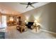 Bright living room with carpet floors connects to dining room with wood table and china hutch at 21012 Picasso Ct # 201, Land O Lakes, FL 34637