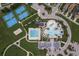 Aerial view of community amenities including pools, tennis courts, and clubhouse, providing residents with recreation at 21590 Violet Periwinkle Dr, Land O Lakes, FL 34637