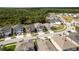 A planned community with tree lined streets, modern houses, and landscaping at 21590 Violet Periwinkle Dr, Land O Lakes, FL 34637