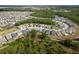 Expansive aerial view of a residential community featuring modern homes, landscaping, and ponds at 21590 Violet Periwinkle Dr, Land O Lakes, FL 34637