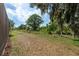 Spacious backyard features lush greenery and mature trees for a private outdoor space at 21590 Violet Periwinkle Dr, Land O Lakes, FL 34637
