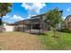 Backyard featuring a screened-in patio with outdoor seating, great for entertaining guests at 21590 Violet Periwinkle Dr, Land O Lakes, FL 34637