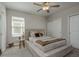 Calm bedroom features a large bed, a window letting in natural light, and neutral tones at 21590 Violet Periwinkle Dr, Land O Lakes, FL 34637