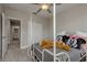 Cozy bedroom featuring a four-poster bed with fun pillows, a ceiling fan, and neutral walls at 21590 Violet Periwinkle Dr, Land O Lakes, FL 34637