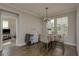 Cozy dining area with a decorative chandelier, a table for four, and access to the living room at 21590 Violet Periwinkle Dr, Land O Lakes, FL 34637