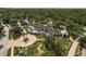 An aerial view of a stately home with a circular driveway, lush landscaping, and a charming covered entryway at 21590 Violet Periwinkle Dr, Land O Lakes, FL 34637