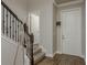 Inviting foyer with wood-look tile flooring, a staircase, and a coat rack enhancing the home's entrance appeal at 21590 Violet Periwinkle Dr, Land O Lakes, FL 34637