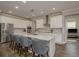 Modern kitchen with stainless steel appliances, a large center island, and stylish bar stool seating at 21590 Violet Periwinkle Dr, Land O Lakes, FL 34637