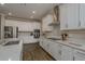 Modern kitchen featuring stainless steel appliances, white cabinetry, countertops, and tile flooring at 21590 Violet Periwinkle Dr, Land O Lakes, FL 34637