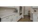 Close-up of kitchen showing white countertop and cabinets and stainless steel appliances at 21590 Violet Periwinkle Dr, Land O Lakes, FL 34637