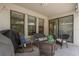 Enclosed patio features an outdoor seating area, patio furniture, grill, and sliding glass doors at 21590 Violet Periwinkle Dr, Land O Lakes, FL 34637