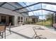 Enclosed patio features an outdoor seating area and furniture, perfect for outdoor dining and lounging at 21590 Violet Periwinkle Dr, Land O Lakes, FL 34637