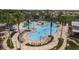 Lagoon style resort pool with palm trees, sun loungers, splash pad, and ample seating areas at 21590 Violet Periwinkle Dr, Land O Lakes, FL 34637