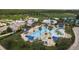 Aerial shot of community pool, pool-side seating, lush landscaping, nearby clubhouse and other amenities at 21590 Violet Periwinkle Dr, Land O Lakes, FL 34637