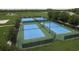 Four blue tennis courts with basketball court, surrounded by manicured landscaping and a walking trail at 21590 Violet Periwinkle Dr, Land O Lakes, FL 34637