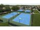 Community tennis and basketball courts featuring well-maintained surfaces, benches, and manicured surrounding landscaping at 21590 Violet Periwinkle Dr, Land O Lakes, FL 34637