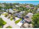 Wide angle aerial view of a single-Gathering home with luscious trees, well-manicured lawns and ocean views at 219 Miramar Ne Blvd, St Petersburg, FL 33704