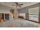 Spacious bedroom featuring a ceiling fan, window with blinds, and exposed wall framing at 219 Miramar Ne Blvd, St Petersburg, FL 33704