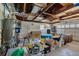 Garage interior view with a water heater, boxes, storage, and exposed ceiling at 219 Miramar Ne Blvd, St Petersburg, FL 33704