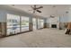 Spacious living room featuring large windows with pool views and a cozy fireplace at 219 Miramar Ne Blvd, St Petersburg, FL 33704