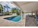 Inviting backyard pool surrounded by brick pavers and a covered patio area at 219 Miramar Ne Blvd, St Petersburg, FL 33704